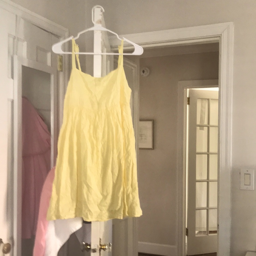 A yellow cotton on dress size small with an open tied back